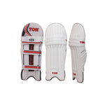 Ton Supreme cricket leg guards featuring premium padding and reinforced knee protection, displayed on a grassy cricket pitch.