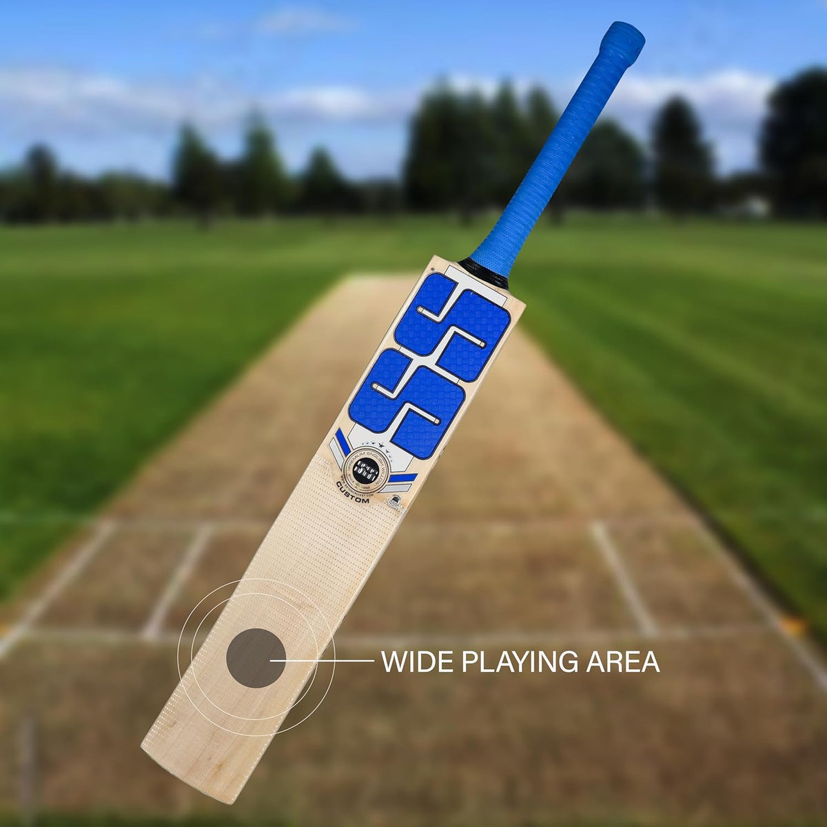 SS Custom English Willow cricket bat displayed on a cricket field, showcasing its fine grain structure and ergonomic handle.