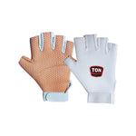 SS Fielding Gloves placed on a grassy cricket field, showcasing grip and padding for optimal catching performance.