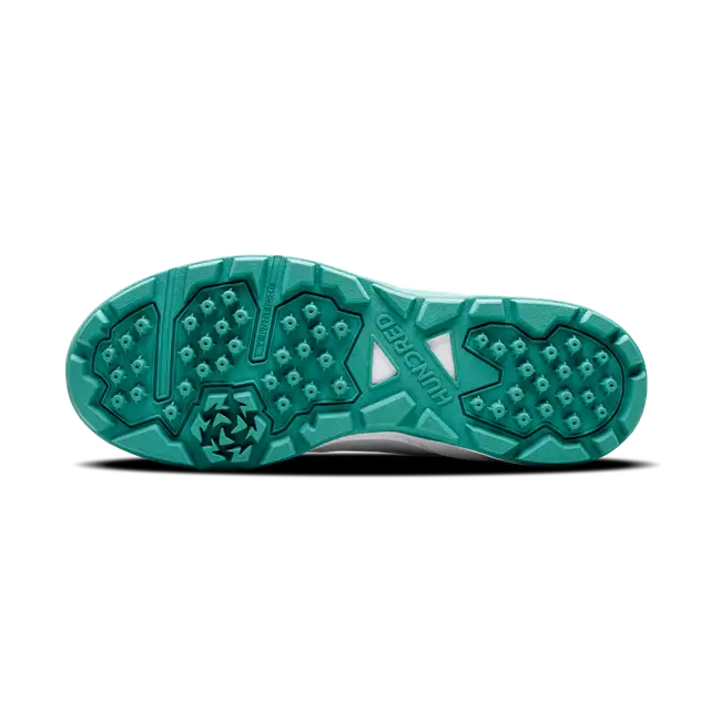 Close-up of Hundred Hyperturf cricket shoes featuring durable sole grip and sleek athletic design.