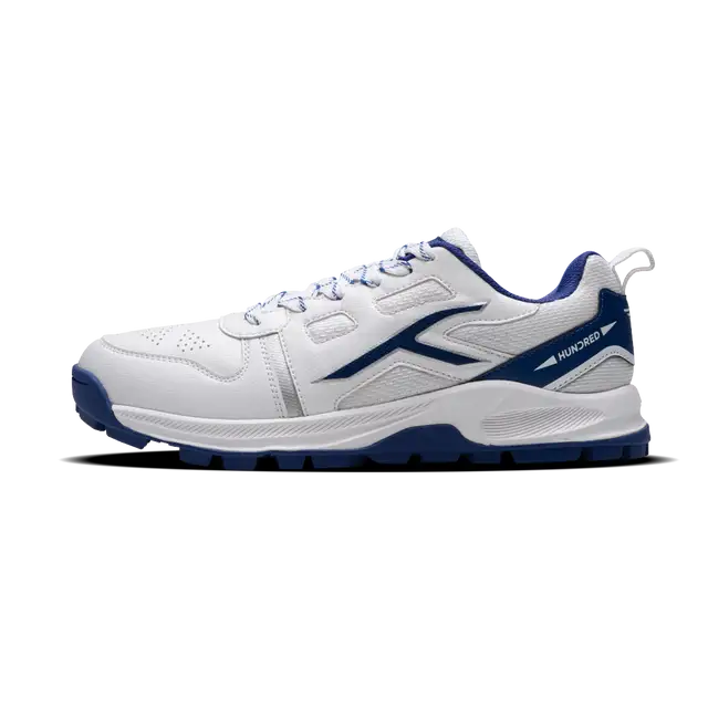 Close-up of Hundred Hyperturf cricket shoes featuring durable sole grip and sleek athletic design.