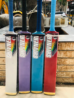 Four colorful cricket bats with 'Shiv Naresh' branding on a wooden surface.