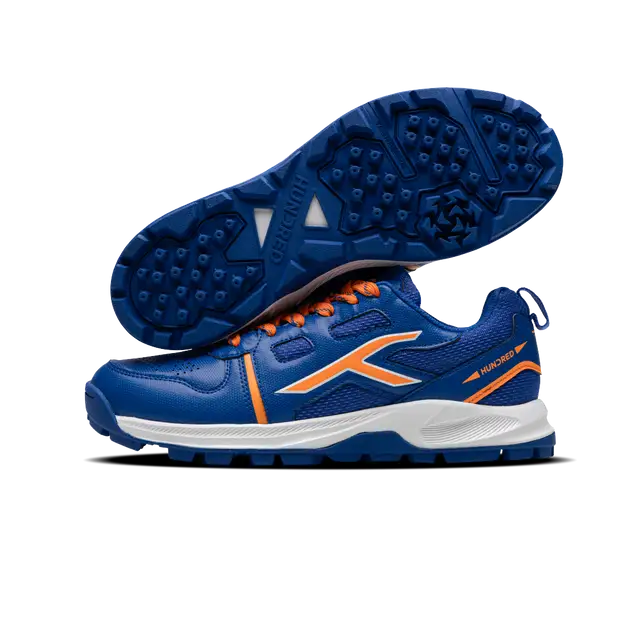 Close-up of Hundred Hyperturf cricket shoes featuring durable sole grip and sleek athletic design.