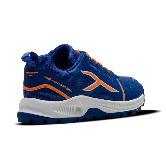 Close-up of Hundred Hyperturf cricket shoes featuring durable sole grip and sleek athletic design.